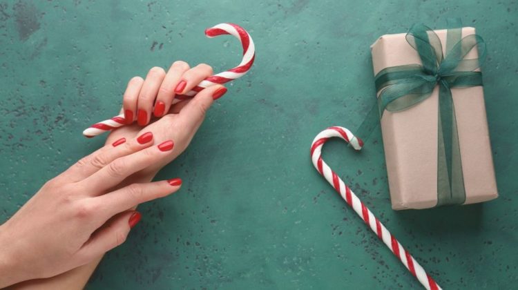 female hands candy canes gift box | Cute Candy Cane Nails Tutorial To Match Your Holiday Look | Featured