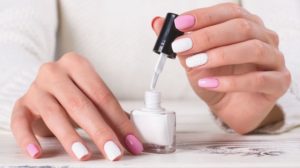 girl paints her nails | Gorgeous White Nail Designs For Every Occasion | Featured