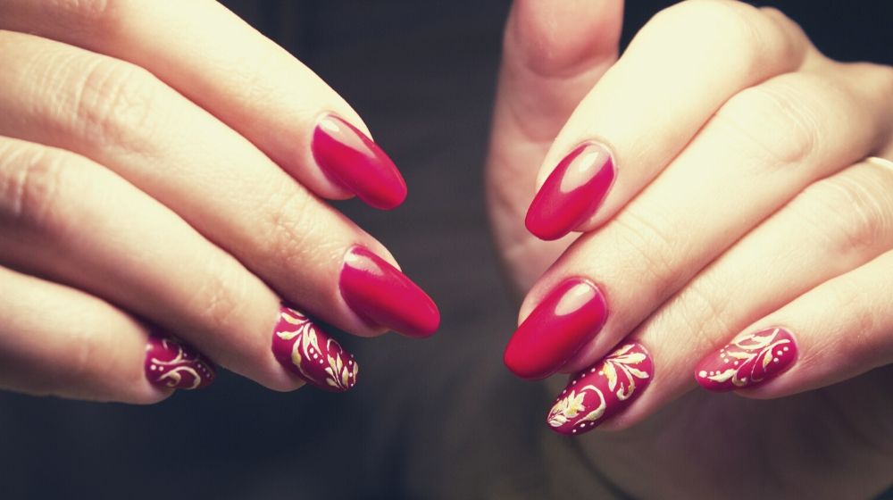 closeup of red nails with gold details | Sexy Red Nail Designs You Should Wear This Christmas