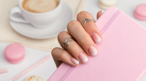 Beautiful manicured hand holding notepad at the office table | How To Do Ombre Nails | The Best Way To Do It Yourself | french ombre gel nails | Featured