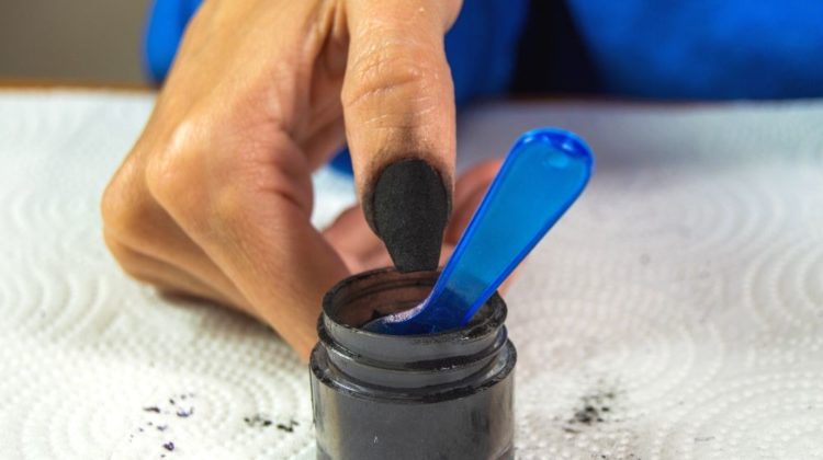woman dipping left thumb black | Facts About Dip Powder Nails You Need Know | Featured