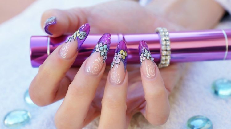 Female hand with stunning purple see-through floral nail art design | Trendy Almond Nail Designs You Should Try | almond nails | almond acrylic nails
