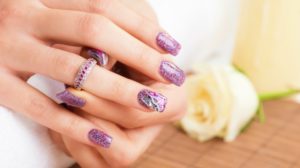 Professionally manicured woman fingernails, with engagement ring | Classy Mauve Nail Designs For An Exquisite Look | mauve color nails | Featured