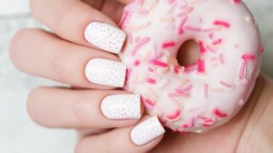 White pattern manicure with pink donut | Try These Cute Donut Nails To Satisfy Your Sweet Cravings | donut nail arts | Featured