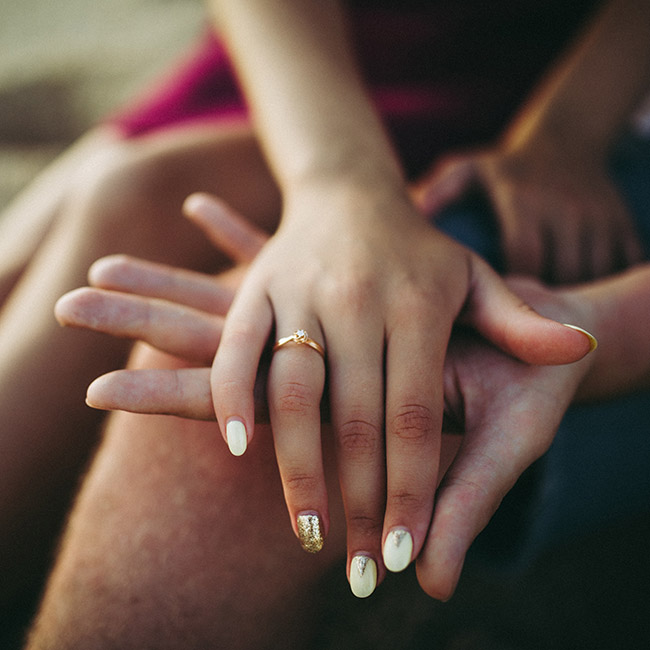 woman's hand placed on top of man's palm | Lizzo's Trendy Milky White Nails We Absolutely Love