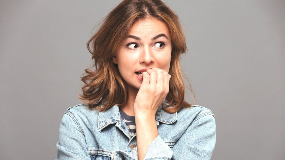 close portrait worried teenage girl denim | Nail Biting | Everything You Need To Know | Featured