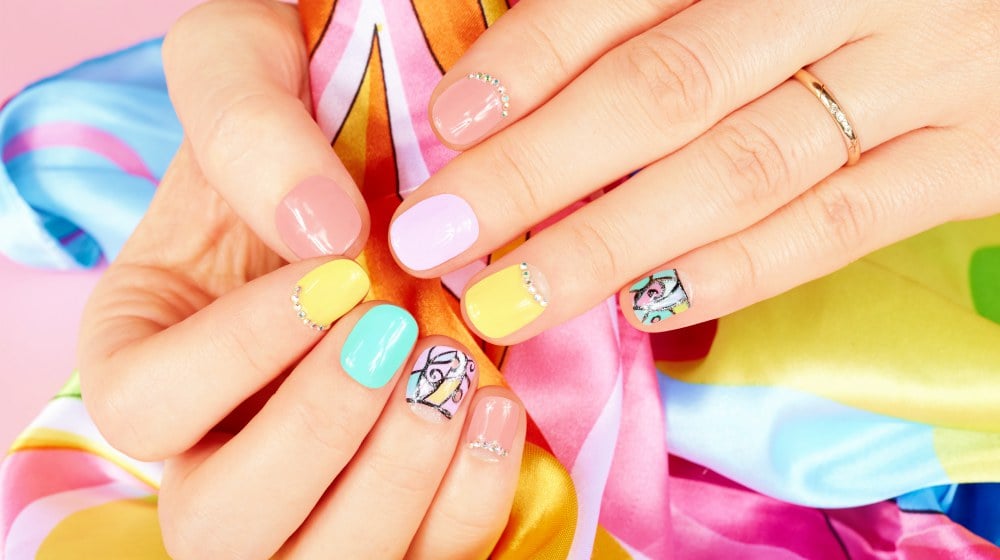 Hands with beautiful manicured nails different colored with nail polish | Classy Short Nail Designs For Every Season | short nail ideas | Featured