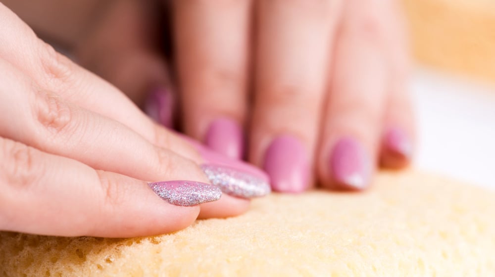 Beautifully manicured woman's fingernails with nice pink nail polish | Easy Falling Glitter Nail Art Ideas And Designs For Valentine's | nail art with glitter | Featured