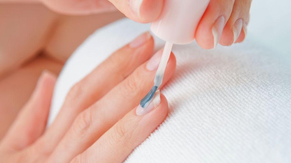 applying top coat on clean nails | Cute Candy Cane Nails Tutorial To Match Your Holiday Look