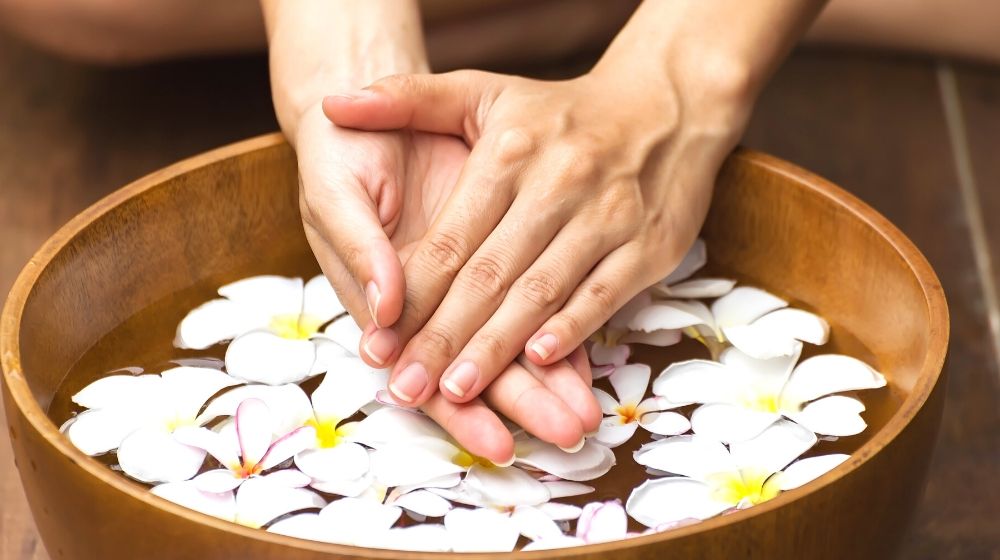 spa treatment product female feet hand | Facts About Dip Powder Nails You Need Know