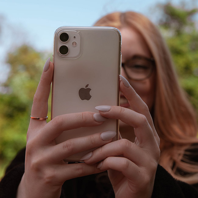 woman holding gold iphone | Lizzo's Trendy Milky White Nails We Absolutely Love